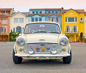 AUT 23 BK0065 01
1971 Mini 1000 Cream Front View On Pavement By Colorful Houses