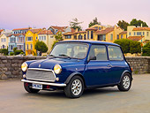AUT 23 BK0066 01
1971 Austin Mini Cooper Blue 3/4 Front View On Pavement By Colorful Houses