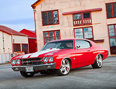 AUT 23 BK0072 01
1970 Chevrolet Chevelle SS 454 Red With White Stripe 3/4 Front View On Pavement By Old Building