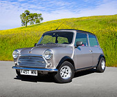 AUT 23 BK0075 01
1971 Austin Mini Cooper Silver And Black 3/4 Front View On Pavement By Grassy Hill