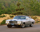 AUT 23 RK0033 01
1970 396 Chevy Chevelle Silver Black Stripe 3/4 Front View On Pavement By Trees