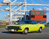 AUT 23 RK0135 04
1970 Plymouth Barracuda 440 Six Pack Green 3/4 Front View On Pavement Trees Blue Sky