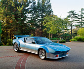 AUT 23 RK0265 05
1971 De Tomaso Pantera Blue And Silver 3/4 Front View On Pavement By Trees Blue Sky
