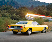 AUT 23 RK0375 02
1970 Plymouth Hemicuda Yellow 3/4 Rear View On Pavement By Bushes