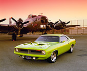 AUT 23 RK0459 02
1970 Plymouth 'Cuda Lime Green 3/4 Front View On Pavement By Plane Red Sky