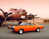 AUT 23 RK0463 04
1970 Dodge Cornet RT Orange And Black 3/4 Side View On Pavement By Plane Orange Sky