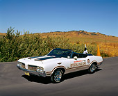 AUT 23 RK0638 05
1970 Oldsmobile Cutlass Supreme Convertible Pace Car White Black Stripe 3/4 Front View On Pavement By Bushes