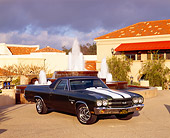 AUT 23 RK0724 04
1970 Chevy SS El Camino Green White Stripe 3/4 Front View By Water Fountain And Building