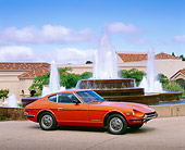 AUT 23 RK0770 05
1972 Datsun 240Z Orange 3/4 Side View On Pavement By Water Fountain