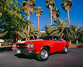 AUT 23 RK0877 01
1970 Chevrolet 454 Chevelle SS Hugger Orange White Stripes 3/4 Low Front View On Pavement By Palm Trees
