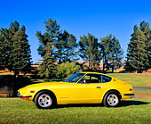 AUT 23 RK1639 01
1971 Datsun 240Z Yellow 3/4 Front View On Grass By Trees