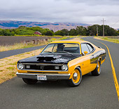 AUT 23 RK1876 01
1970 Plymouth Duster Yellow And Black 3/4 Front View On Road By Hills