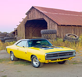 AUT 23 RK1906 01
1970 Dodge Charger R/T Yellow And Black 3/4 Front View On Dirt By Barn