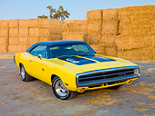 AUT 23 RK1910 01
1970 Dodge Charger R/T Yellow And Black 3/4 Front View On Dirt By Straw Bales