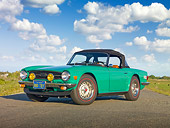 AUT 23 RK1971 01
1975 Triumph TR6 Green 3/4 Front View On Road By Marsh