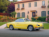 AUT 23 RK1992 01
1973 VW Karmann Ghia Coupe Yellow 3/4 Front View On Pavement By House