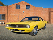 AUT 23 RK2005 01
1970 Plymouth Barracuda 440 Six Pack Yellow 3/4 Front View On Gravel By Brick Building