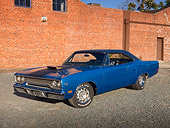 AUT 23 RK2019 01
1970 Plymouth Road Runner Hemi Blue With Black Stripe 3/4 Front View On Gravel By Brick Building