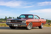 AUT 23 RK2110 01
1970 Plymouth GTX Burnt Orange With Black Stripe 3/4 Front View On Pavement By Fence