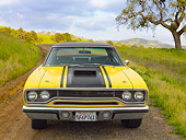 AUT 23 RK2155 01
1970 Plymouth Road Runner 440 Six Pac Yellow With Black Stripe Front View On Dirt Road In Grassy Hills