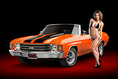 AUT 23 RK2186 01
1972 Chevrolet Chevelle SS Convertible Chrome Orange With Jet Black Stripes 3/4 Front View In Studio With Swimsuit Model