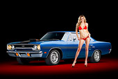 AUT 23 RK2191 01
1970 Plymouth GTX Blue 3/4 Front View In Studio With Swimsuit Model