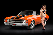 AUT 23 RK3374 01
1972 Chevrolet Chevelle SS Convertible Chrome Orange With Jet Black Stripes 3/4 Front View On Pavement With Swimsuit Model