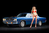 AUT 23 RK3376 01
1970 Plymouth GTX Blue 3/4 Front View On Pavement With Swimsuit Model
