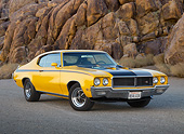 AUT 23 RK3407 01
1970 Buick GSX Saturn Yellow And Black 3/4 Front View On Pavement By Rock Wall
