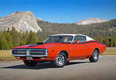 AUT 23 RK3425 01
1971 Dodge Hemi Charger Orange With White Top 3/4 Front View On Pavement By Evergreen Trees And Mountains