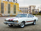 AUT 23 RK3458 01
1974 Ford Maverick White With Red Stripes 3/4 Front View On Pavement By Old Factory Building