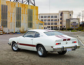 AUT 23 RK3459 01
1974 Ford Maverick White With Red Stripes 3/4 Rear View On Pavement By Old Factory Building