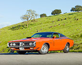 AUT 23 BK0013 01
1971 Dodge Charger 440 Magnum R/T Orange 3/4 Front View On Pavement By Hill