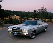 AUT 23 RK0035 03
1970 Chevy 396 Chevelle Silver Black Stripe 3/4 Front View On Pavement By Trees At Dusk Filtered