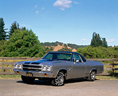 AUT 23 RK0041 02
1970 Chevrolet El Camino SS 454 Silver Black Stripe 3/4 Front View On Pavement By Fence And Trees Blue Sky
