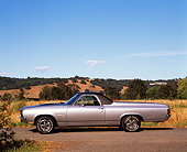 AUT 23 RK0044 01
1970 Chevrolet El Camino SS 454 Silver Profile On Pavement Hills Blue Sky