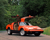 AUT 23 RK0076 02
1975 Bricklin Orange And Black 3/4 Front View Doors Open On Pavement By Trees