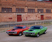 AUT 23 RK0090 07
1971 & 1972 Plymouth Road Runners Orange & Green 3/4 Front View On Pavement By Factory