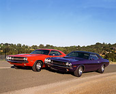 AUT 23 RK0112 04
1970 Purple and Orange Dodge Challenger 426 Hemis 3/4 Front On Road With Trees And Blue Sky