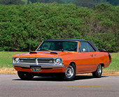 AUT 23 RK0128 04
1970 Dodge Dart 340 Swinger Orange And Black Low 3/4 Front View On Pavement By Bushes