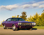 AUT 23 RK0159 01
1970 Dodge Challenger Plum Crazy Low 3/4 Front View On Pavement By Grass And Trees Clouds Blue Sky