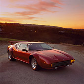 AUT 23 RK0244 01
1972 De Tomaso Pantera Burgundy 3/4 Front View On Pavement Orange Sky At Sunset
