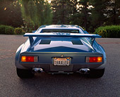 AUT 23 RK0271 01
1971 De Tomaso Pantera Blue And Silver Rear View On Pavement Brake Lights On Trees Background
