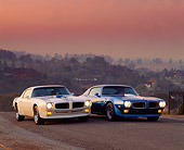 AUT 23 RK0282 03
1970 & 1971 Pontiac Trans Am Blue And White 3/4 Front View On Pavement Headlights Hazy Sky