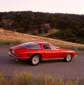 AUT 23 RK0311 02
1971 Iso Grifo Red 3/4 Rear View On Pavement By Hills