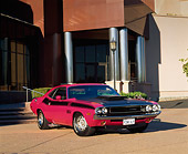 AUT 23 RK0315 02
1970 Dodge Challenger T/A Panther Pink 3/4 Front View On Pavement In Front Of Building