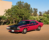 AUT 23 RK0318 01
1970 Dodge Challenger T/A Pink And Black 3/4 Front View On Pavement By Bushes