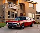 AUT 23 RK0381 02
1970 Chevrolet Nova SS 396 Red 3/4 Front Vie On Driveway By House