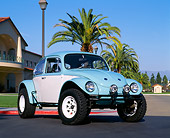 AUT 23 RK0408 01
1970 VW Baja Bug Light Blue And White Low 3/4 Front View On Pavement By Building And Palm Trees Blue Sky