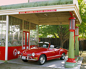 AUT 23 RK0417 01
1971 VW Karmann Ghia Convertible Red 3/4 Front View By Old Gas Station